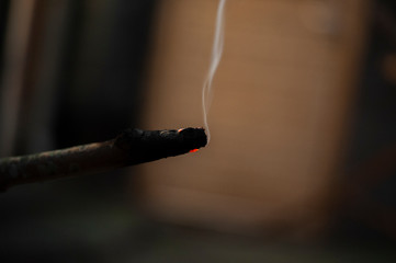 burning piece of wood with abstract background