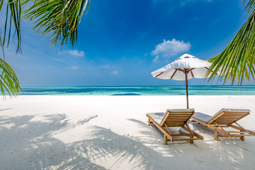 Luxury beach resort, beach loungers near the sea with white sand over sea Topical island...