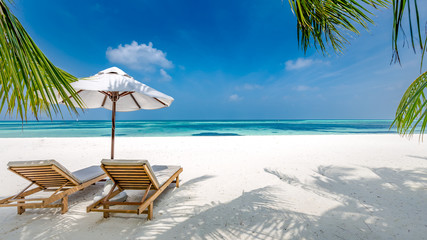 Luxury beach resort, beach loungers near the sea with white sand over sea Topical island background, summer vacation concept, holiday and tourism design. Exotic landscape, inspirational leisure banner