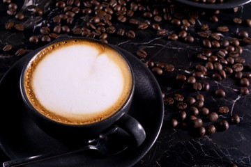 fresh flat white coffee on black marble table