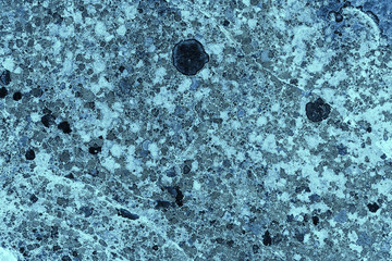 Vintage blue background. Rough painted wall of sapphire color. Imperfect plane of blue colored. Uneven old decorative toned backdrop of cyan tint. Texture of sapphirine hue. Ornamental stony surface.