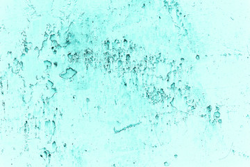 Vintage azure background. Rough painted wall of turquoise color. Imperfect plane of cyan colored. Uneven old decorative toned backdrop of aqzure tint. Texture of teal hue. Ornamental stony surface.