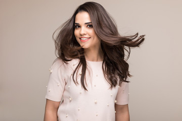 Obraz premium Gorgeous young woman tossing her perfect long hair in a studio