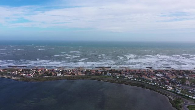 Residential coastline city Frontignan front beach aerial drone view.  Windy day 