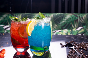 three cocktails with lime and ice