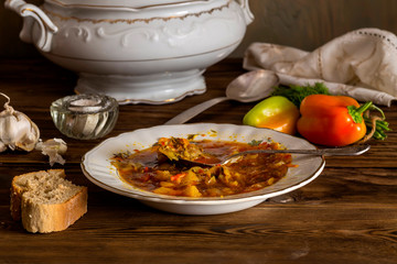 Plate of borsch on a wooden table (Ukrainian food)