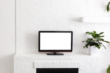 Television put on wood table, background white wall