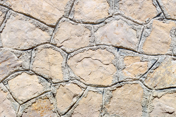 The background old brown stony wall