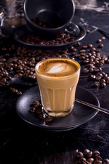 cup of coffee with beans on a black background
