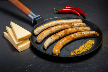 homemade fried thin sausages, mustard, chili, and hard cheese