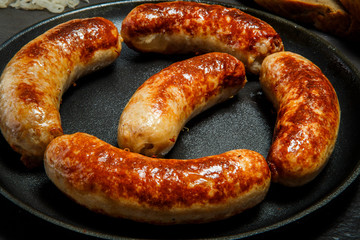 macro delicious ruddy meat wieners fried in large frying pan