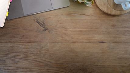 Wood office desk table with laptop office supplies and copy space.
