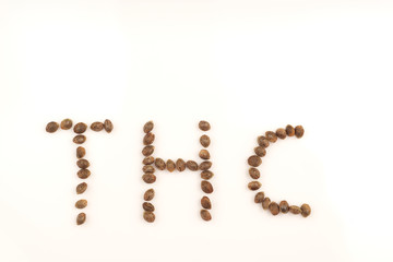 Hemp seeds on white background macro letters thc