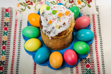 top view of decorated easter bread and dyed easter eggs