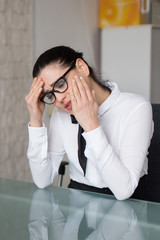 Confused businesswoman has tooth ache in office