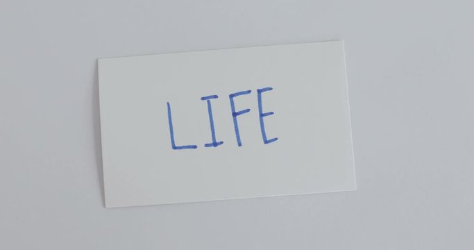 hand flip the paper card of  work  to life word , motivation for work life balance concept