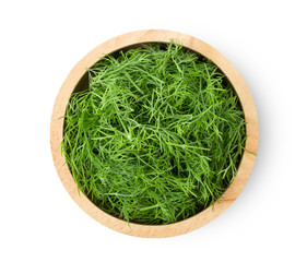 Fresh dill in wood bowl isolated on white background. top view