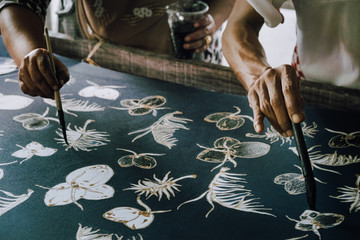 The close-up hand of  artist is painted on the fabric