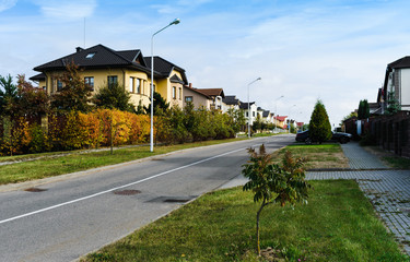Fototapeta na wymiar Quiet street with houses, car and trees