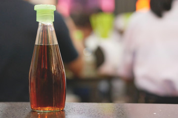 The bottle of fish sauce.