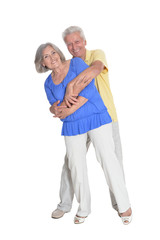Senior couple hugging isolated on white background, full length