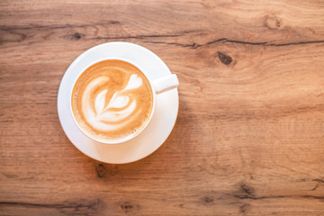 Fresh flavored coffee art on wooden background.