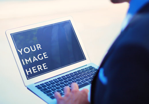 Person Using Laptop on Street Mockup