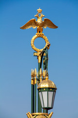 Fototapeta na wymiar Lantern with a Golden eagle on Panteleimon bridge built in the 18th century. Saint-Petersburg