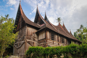 Wooden rural house with an unusual roof in the village of the Minangkabau people on the island of Sumatra, Indonesia.