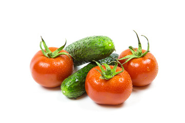 Fresh red tomatoes and cucumbers isolated on white background Food and drink Agriculture