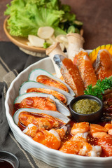 Close up raw seafood, fish, mussels, oyster, mushroom and meat in a set preparing for serve in a restaurant