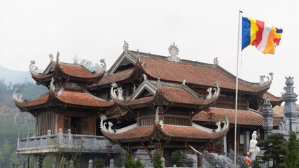 Fototapeta premium Sapa Vietnam pagoda at Fansipan in morning.Fansipan is the highest mountain in the Indochinese Peninsula with longest cable road in the world ( chinese word is name of temple Bao An thien tu )