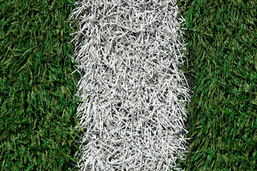 white stripe of a football field with artificial turf