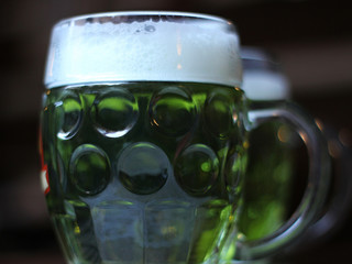 closeup of a glass jar with dyed green beer