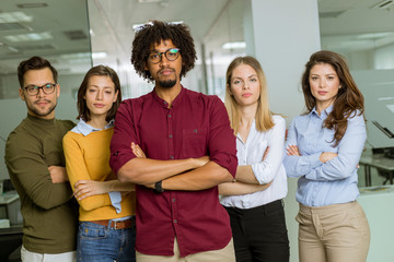 Portrait of successful creative business team looking at camera and smiling