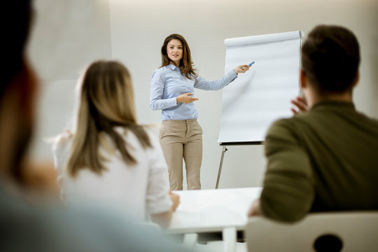 Creative Positive Female Leader Talking About Business Plan With Students During Workshop