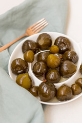 Fig jam in whtie ceramic plate on white tabletop