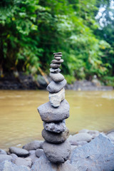 Stacked zen stones at Tegenungan Waterfall at Bali, Indonesia