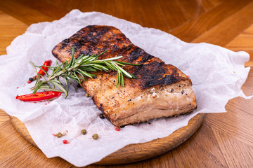 Grilled beef fillet steaks with herbs and spices on wooden background