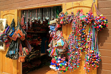 Colorful traditional crafts in the souvenir shop of San Pedro de Atacama town, northern Chile,...