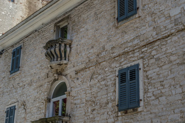 Fototapeta na wymiar Old house with windows and a balcony