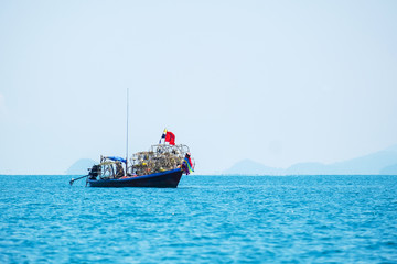 Fisherman Working in the Sea with Shell to Trap a Small Squid