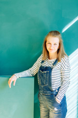 Spring and summer theme in the interior. Young mother in a photo Studio on a green background.