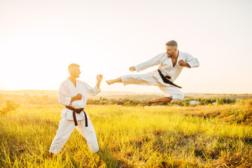 Karate fighters, kick in flight on training fight