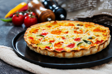 VEGETABLE PIE WITH CHERRY TOMATOES, GRILLED PEPPERS AND COURGETTES With fresh eggs and fresh cream