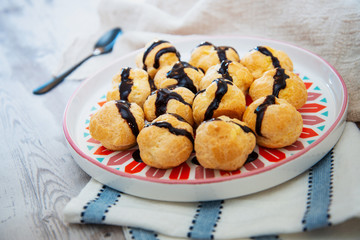 Profiterole with vanilla and chocolate sauce