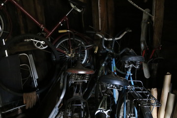 Obraz na płótnie Canvas old bicycles and tools in the garage, shed
