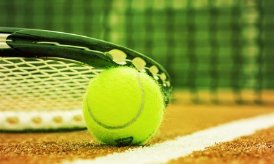 Tennis game. Tennis ball and racket on court background