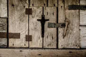 Cut-out cross on a wooden door