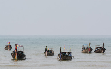 KRABI, THAILAND - MARCH 2019: long tail wooden boats moored at Railey beach